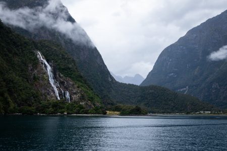 Misty waterfall, mountains and lake