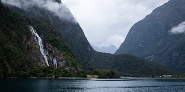 Misty waterfall, mountains and lake